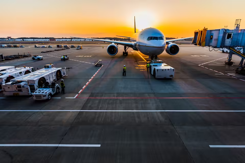 Passenger aircraft viewed through a modern airport terminal window
