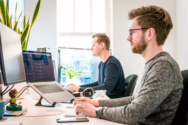 Automation engineers reviewing RPA workflows in a modern digital operations center