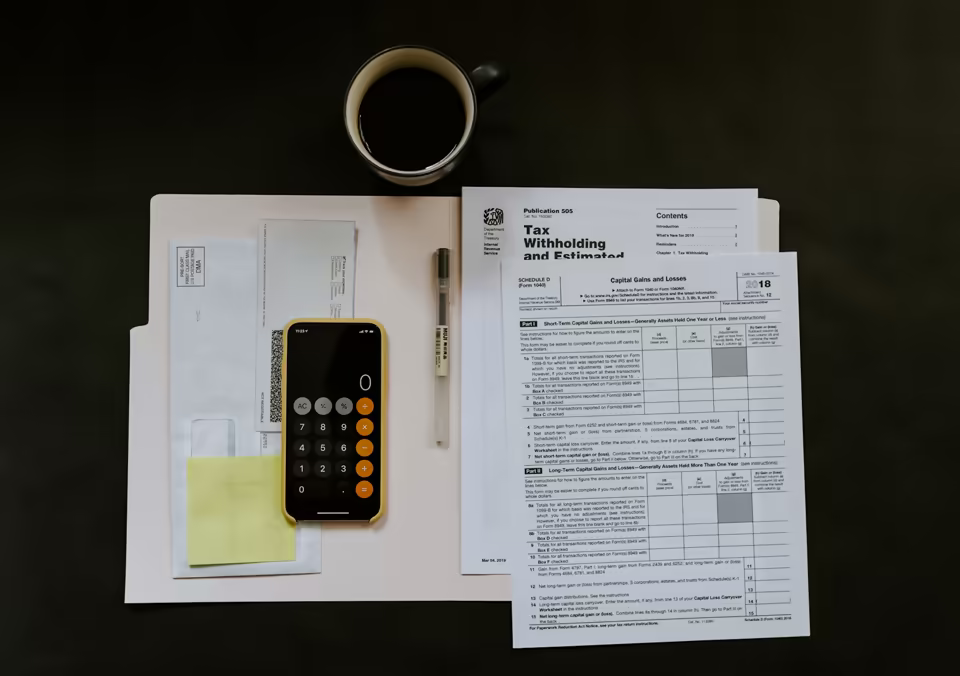 Finance professional reviewing invoices and receivables reports at a desk