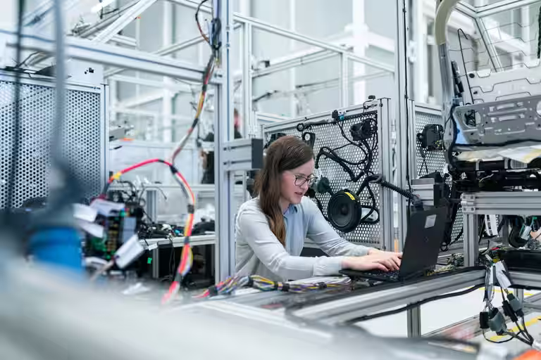 Engineers reviewing AI and automation dashboards in a modern office
